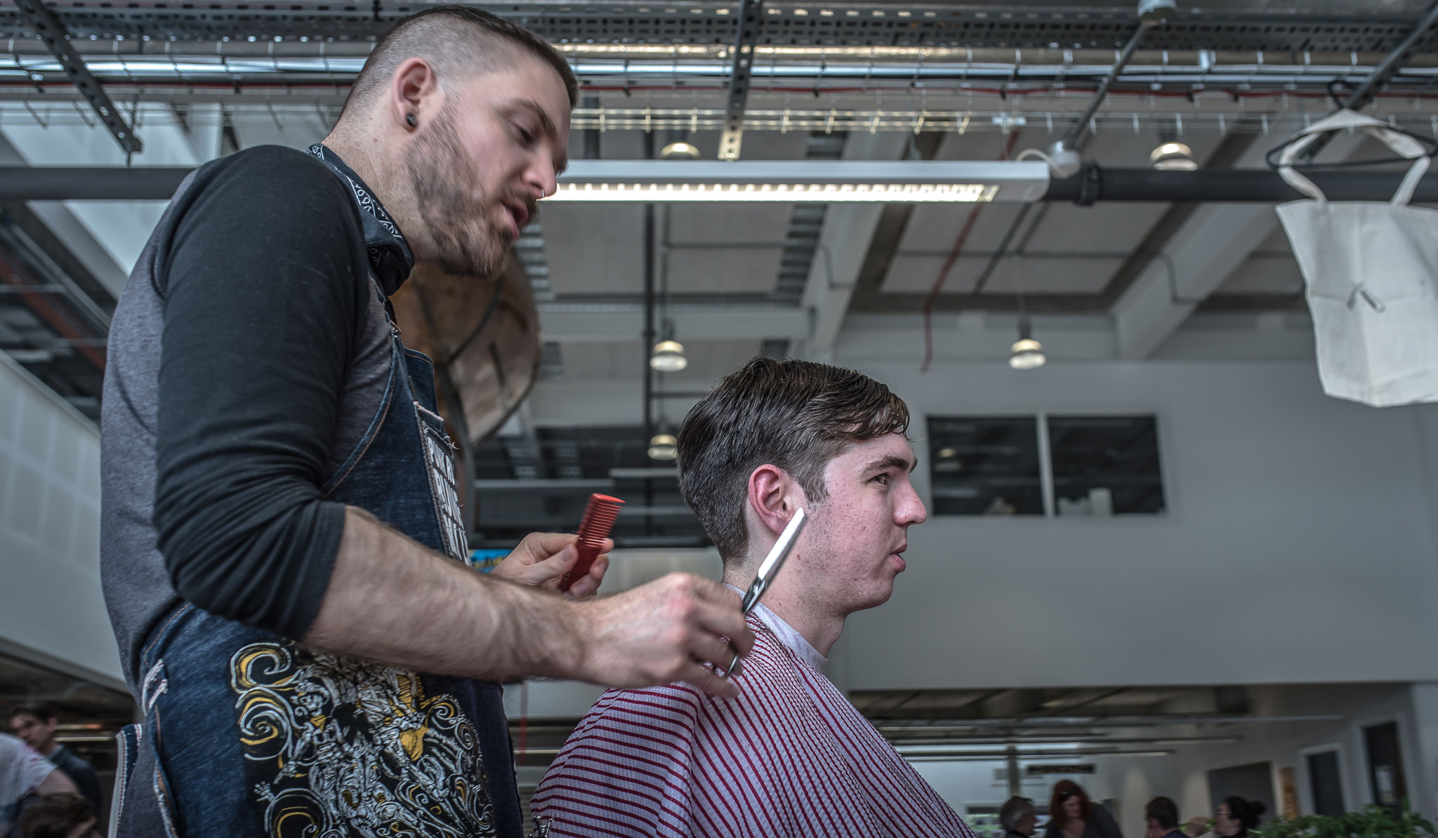 Pop up Barber Cut the Punx with scissorsr and customer