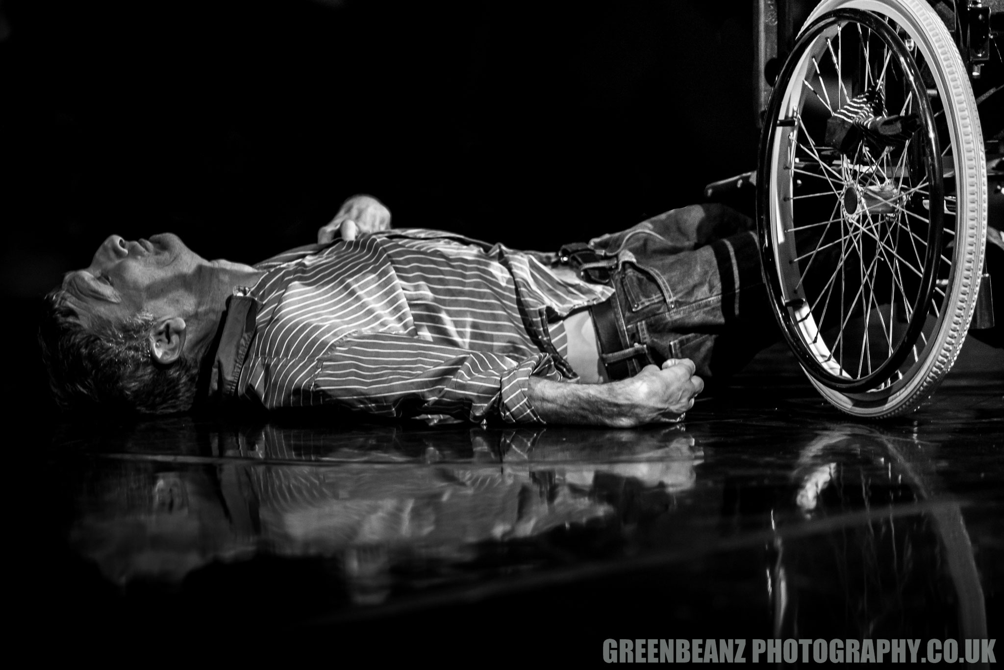Black and White Photograph ofdisabled dancer on floor next to wheelchair