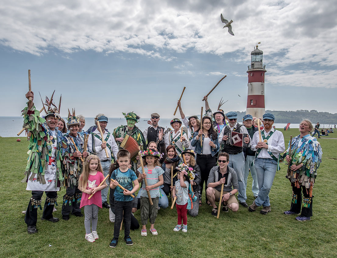 Morris Dancers on Plymouth Hoe in front of lighthouse